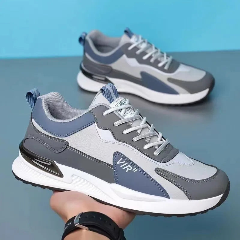 Men's colour block mesh sneakers in black, grey, and white with round toe and flat heel.