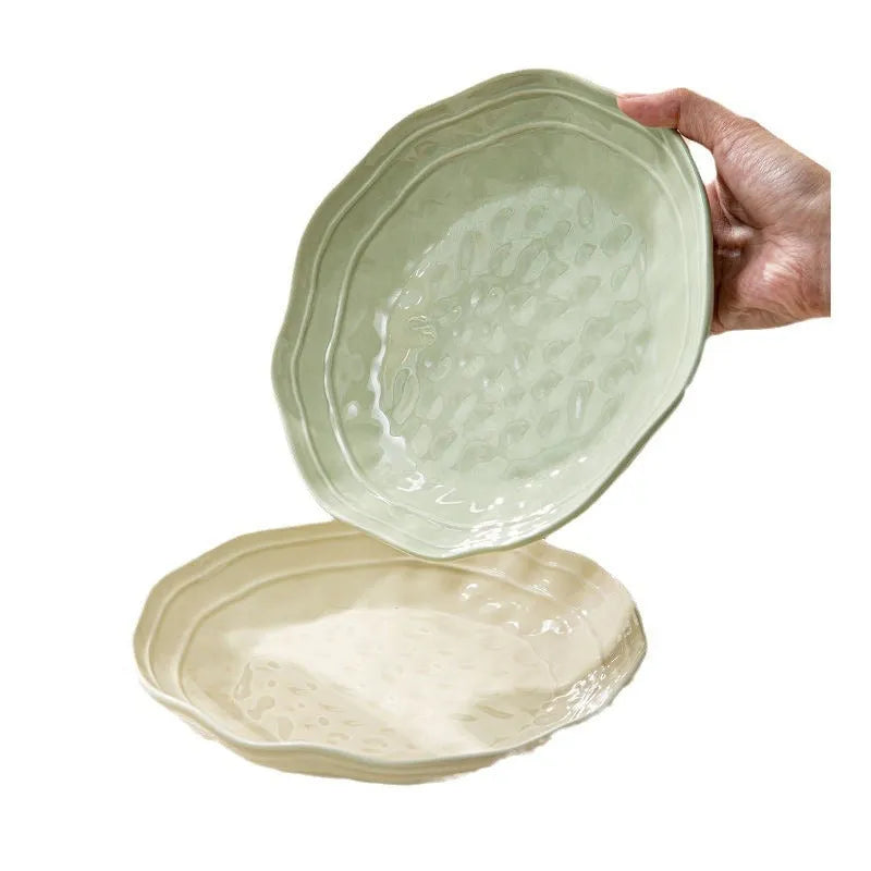 Seven-piece solid colour ceramic tableware set with modern Japanese style design on a table.
