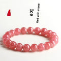 Women's geometric crystal bracelet with red rhodochrosite stone and a Longevity Lock charm on a wrist.