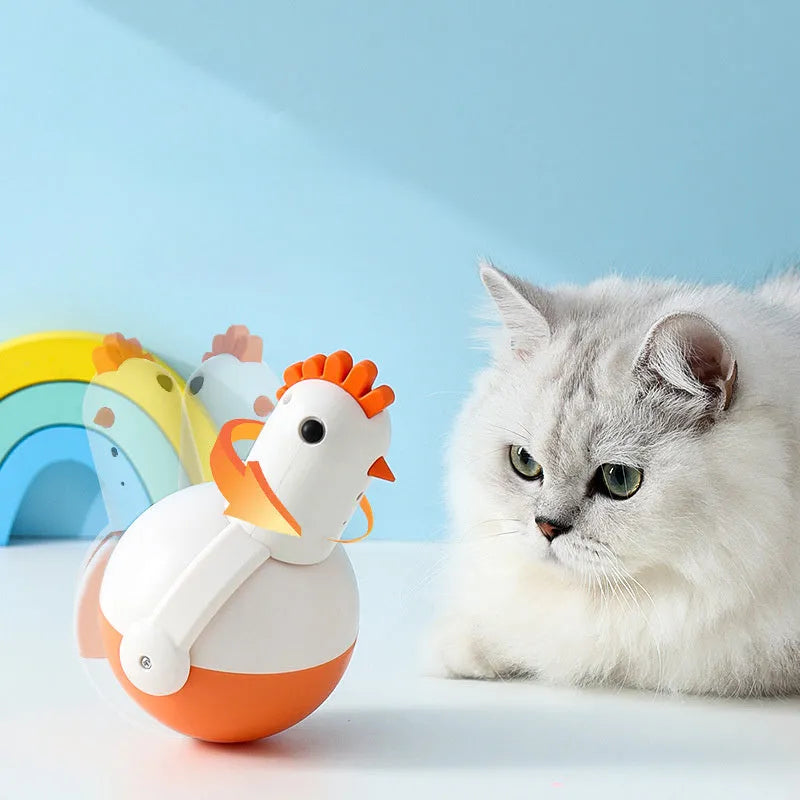 Green and orange electric cat toy chicken with laser light and sound features on a floor
