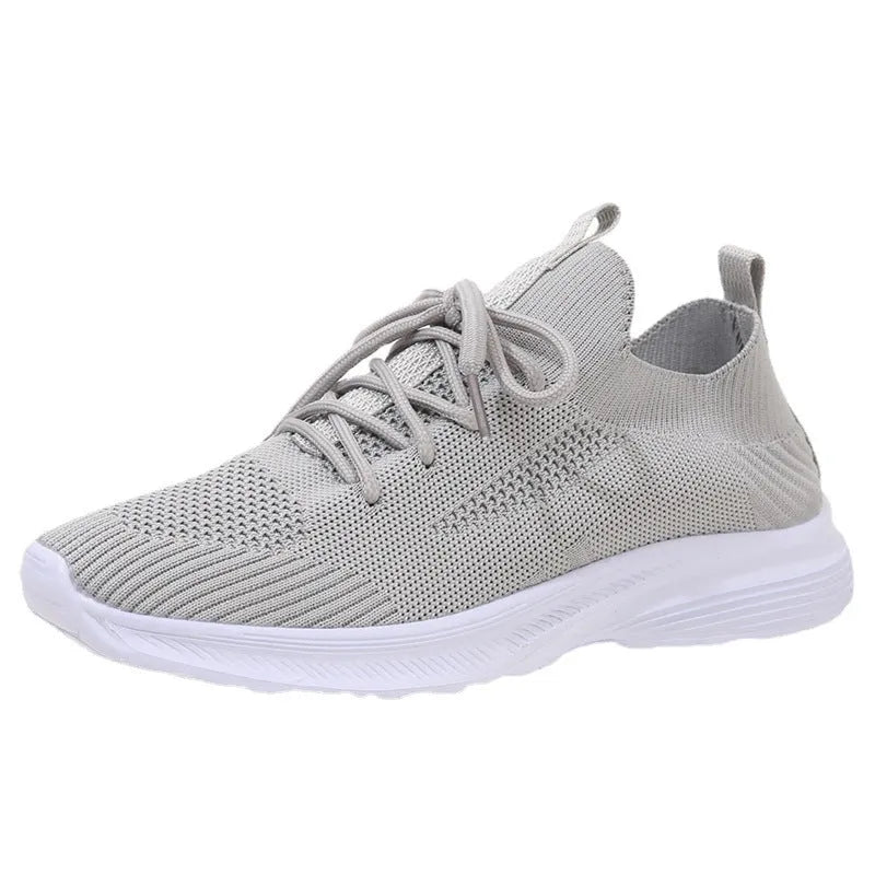 Women's low-top running shoes in Creamy White with mesh detailing and a flat rubber sole.