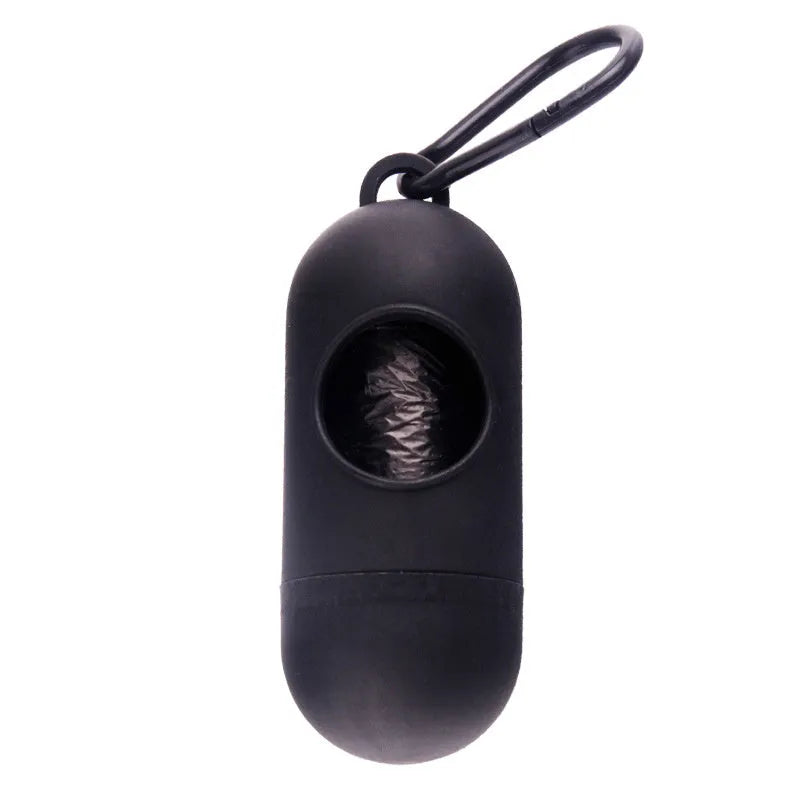 Black plastic dog poop bag holder with a metal side hook and Velcro strap, showing compact size.