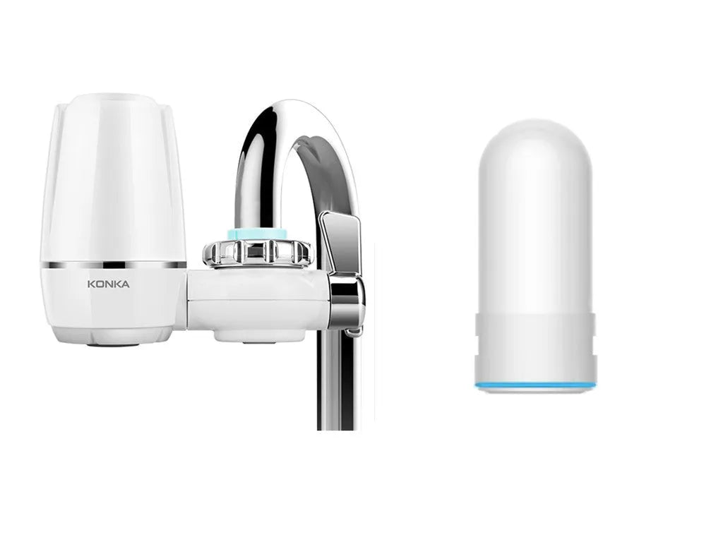 White plastic kitchen tap water filter with ceramic cartridge and universal adapter kit on a counter.