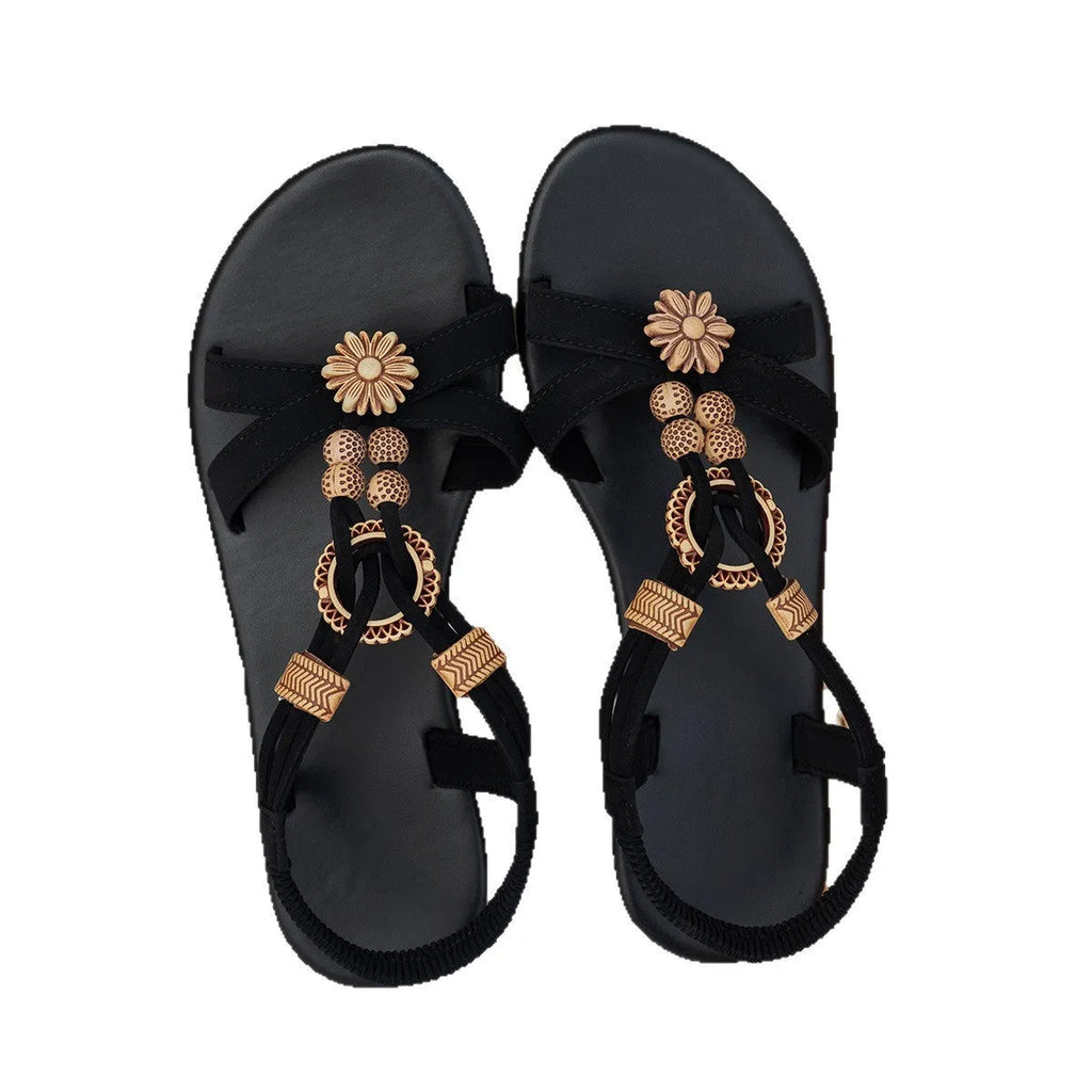 Black ethnic style women's flat sandals with beaded weave and rhinestone decoration on a rubber sole.