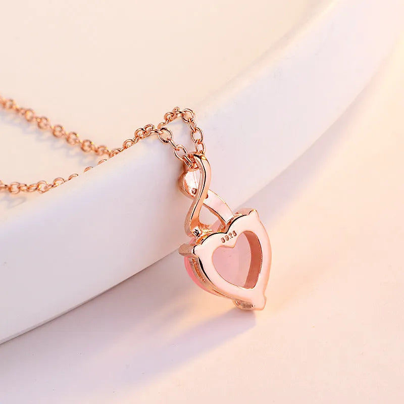 Women's heart-shaped pink crystal pendant with rose gold electroplated finish and matching cross chain