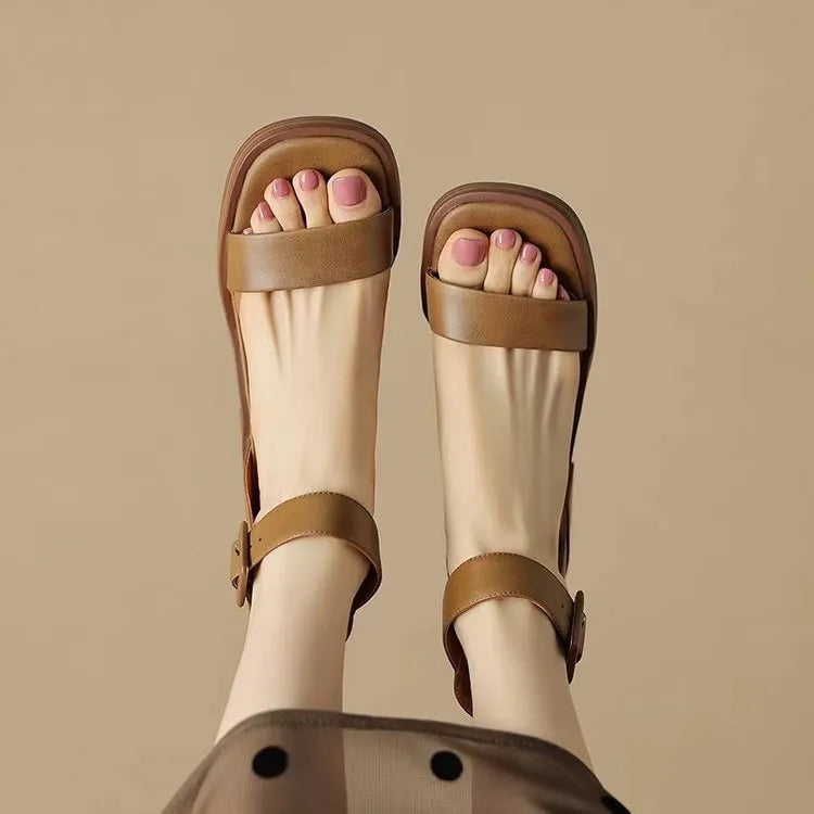 Women's white retro ankle-strap platform high heels with a round toe on a neutral background.