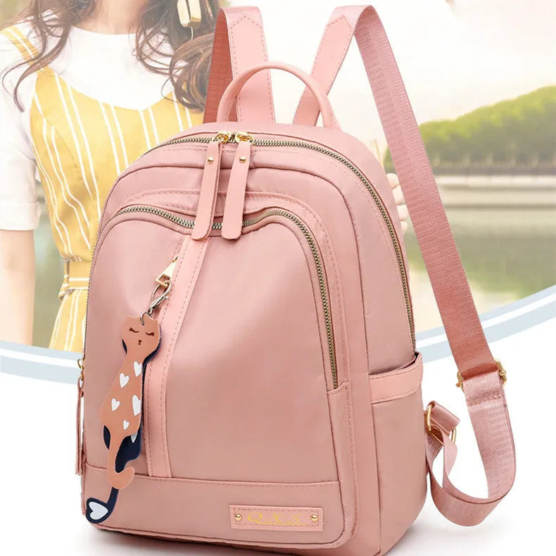 Women's casual backpack in black or pink with 20L capacity, waterproof nylon construction, and internal organiser compartments