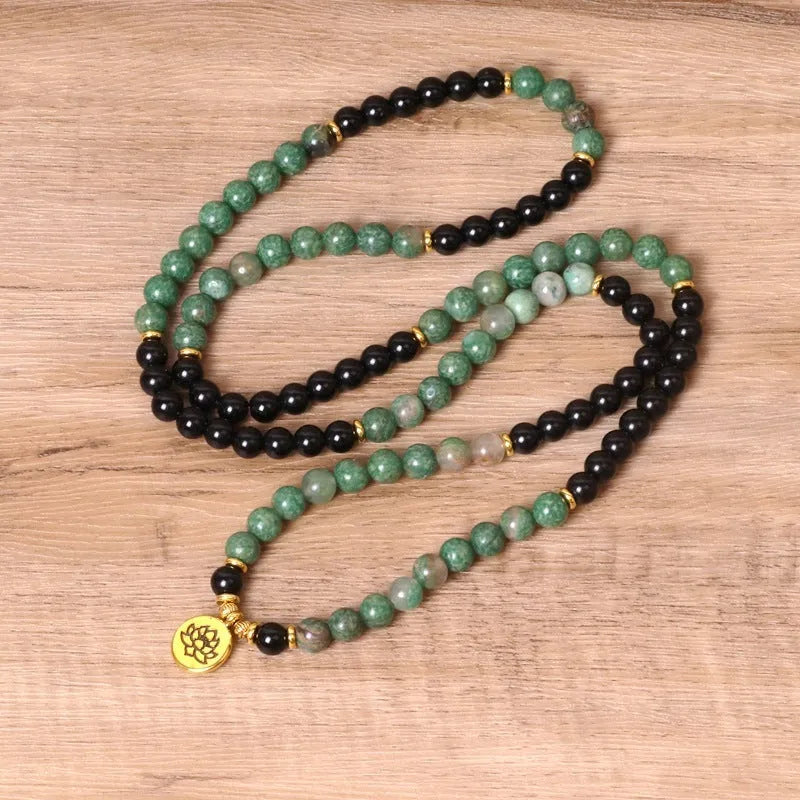Green and black elastic beaded fashion bracelet with alloy clasp showing adjustable design