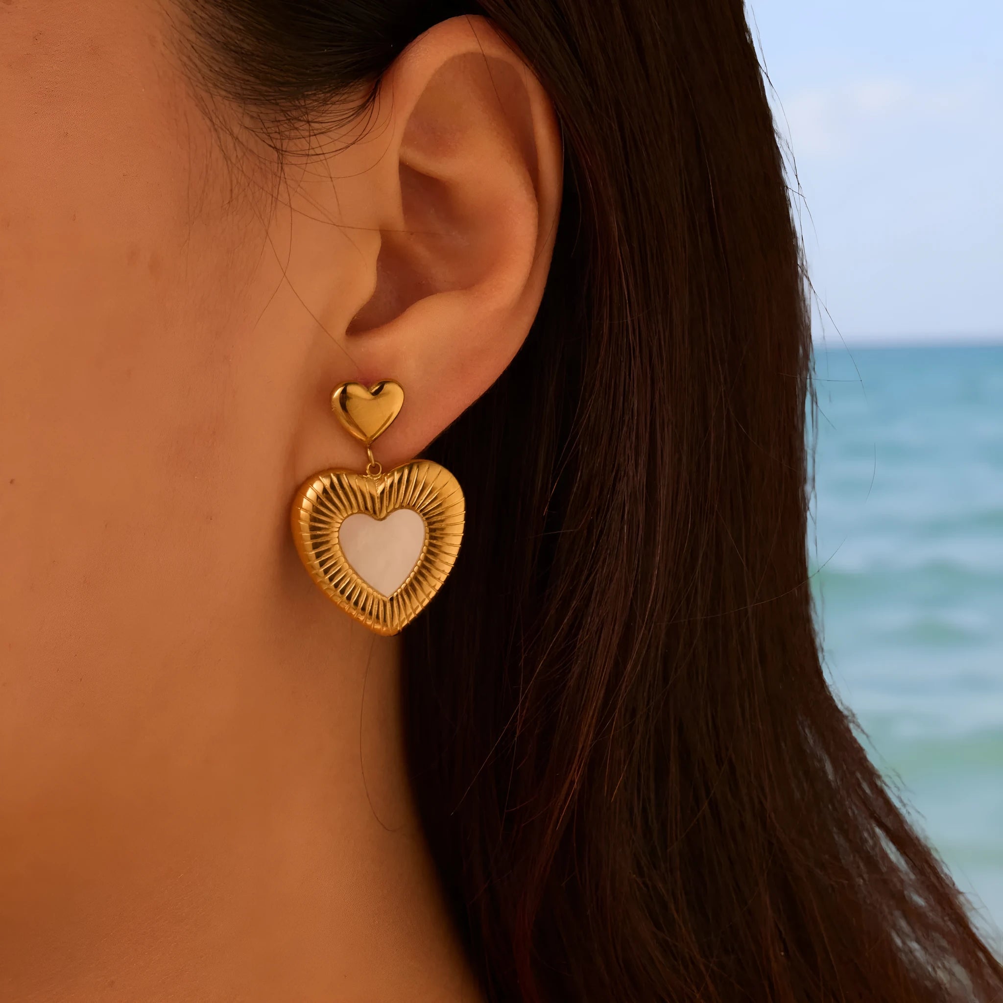 Gold electroplated heart-shaped earrings on stainless steel backing for women's fashion wear