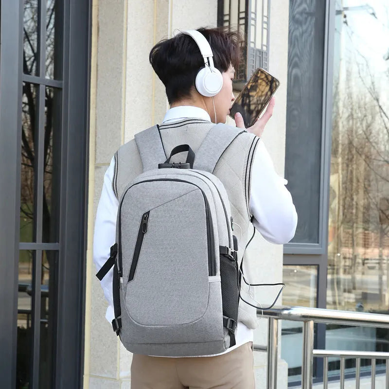 Blue Oxford cloth computer backpack with front pocket, shown next to grey and black colour options.