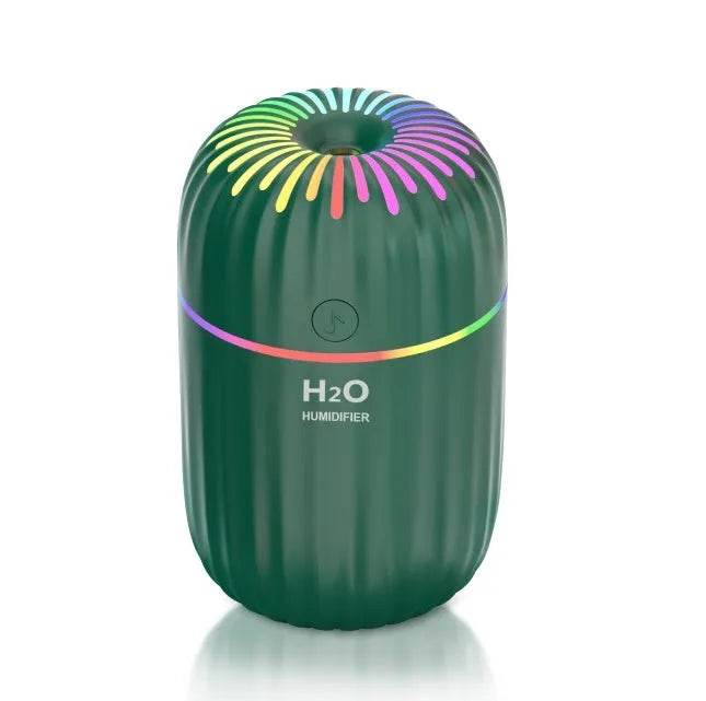 Compact white USB mini humidifier with 300ml water tank on desk beside laptop