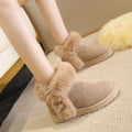 Women's winter snow boots in beige with fluffy platform, round toe, and artificial wool lining on a white background