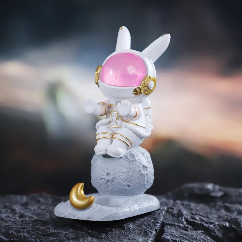 Space rabbit resin mobile phone stand in pink for desktop use
