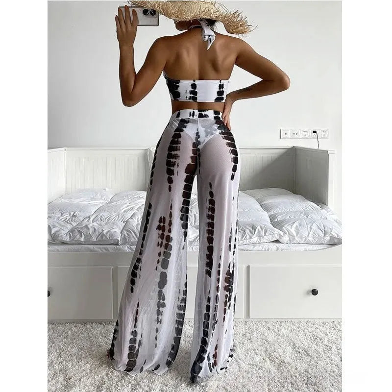 Women's three-piece swimsuit set with bikini top, underpants, and mesh trousers in printed design.