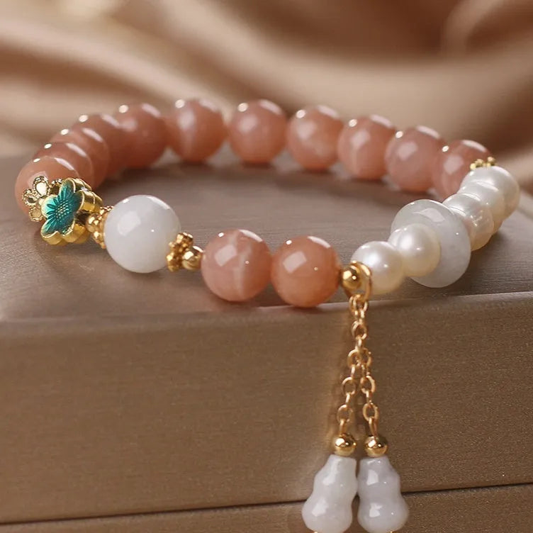 Natural sunstone bracelet with orange sunstone jade calabash pendant and moonstone beads on display