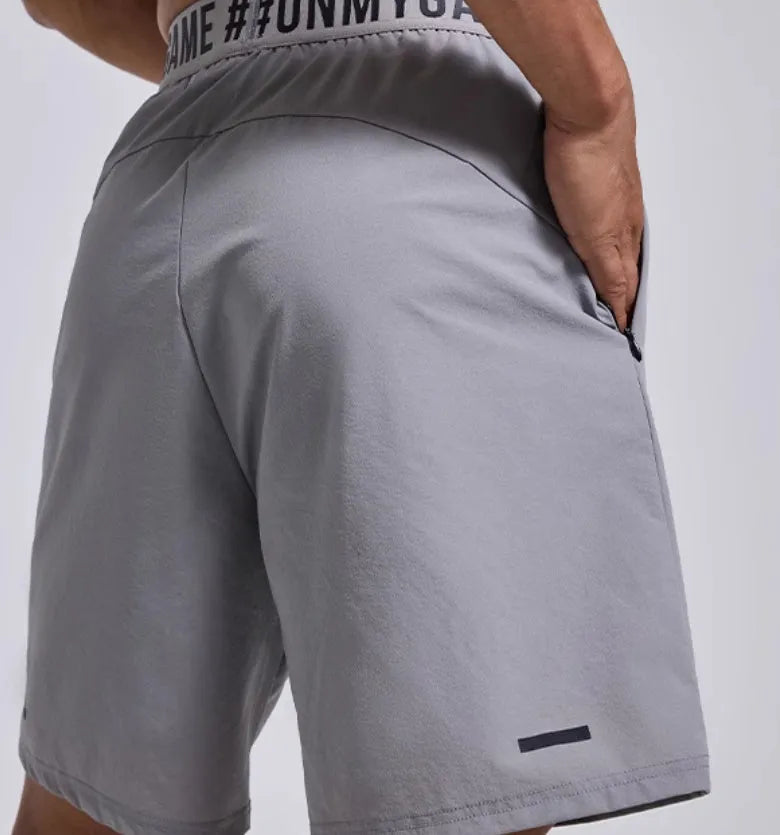 Men's black breathable sports shorts with elastic waistband and loose cropped design