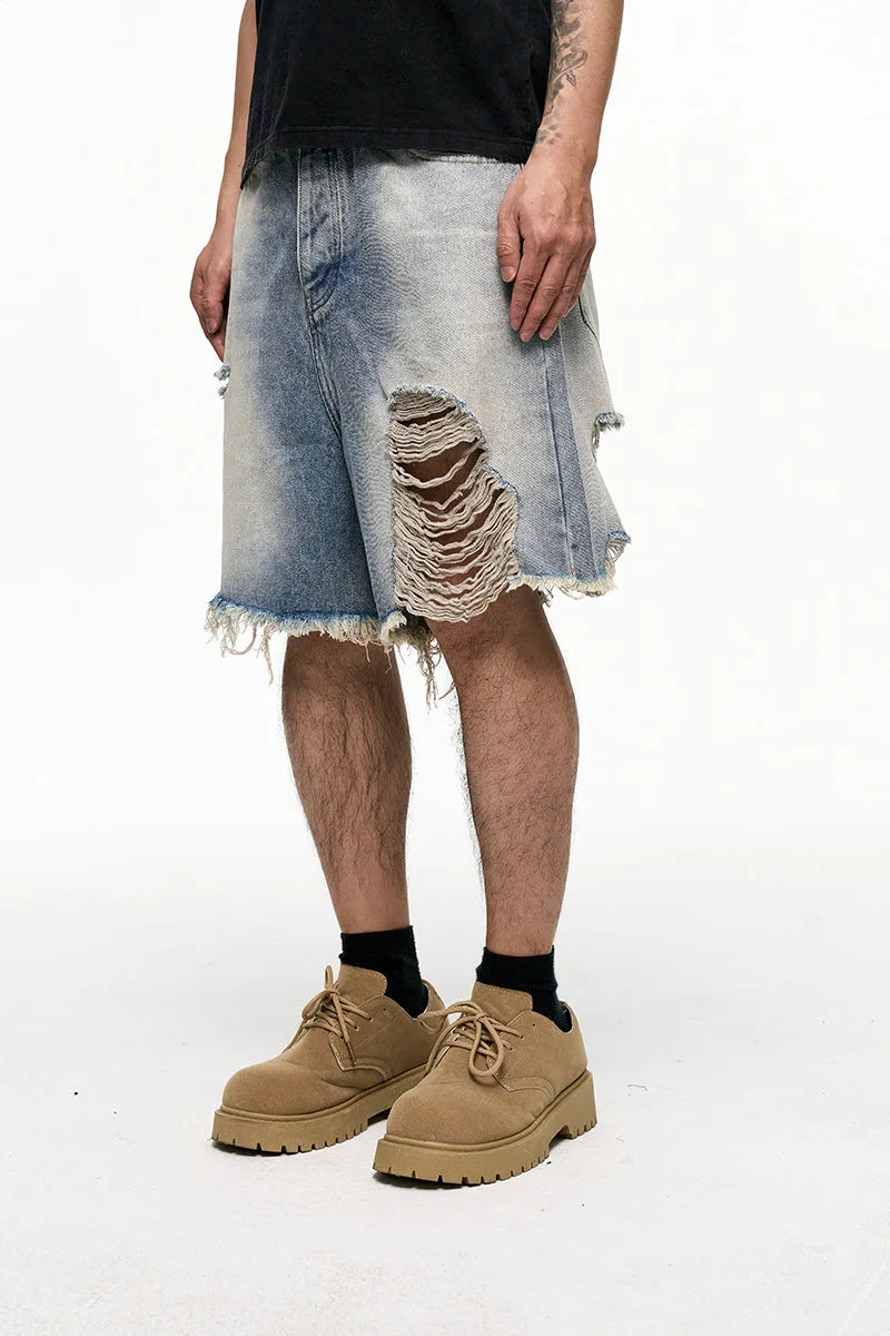 Men's light blue baggy denim shorts with wide leg and retro washed finish on a mid waist.