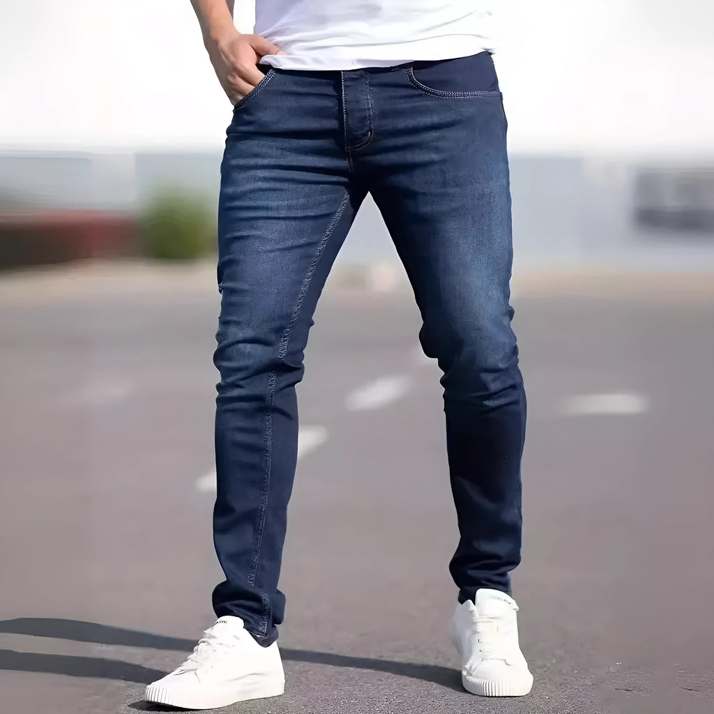 Men's dark blue slim casual jeans with street fashion styling and mid waist design