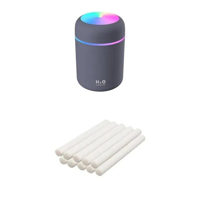 Pink USB desktop humidifier with colourful LED lights and 300ml water tank on wooden desk