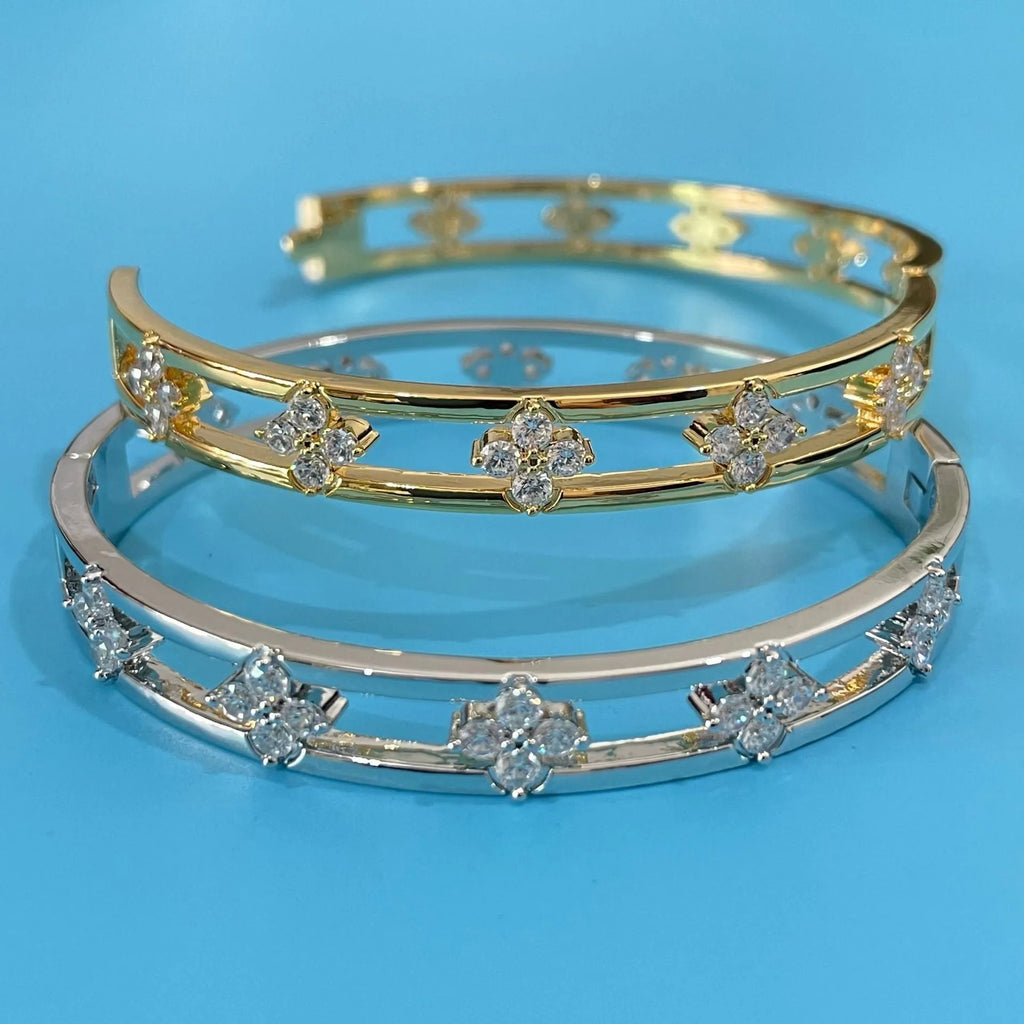 Women's hollow bracelet with zircon stones and four-leaf clover charm in gold and silver options