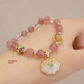 Women's bracelet with strawberry quartz and gray jade stones and ethnic metal decorations