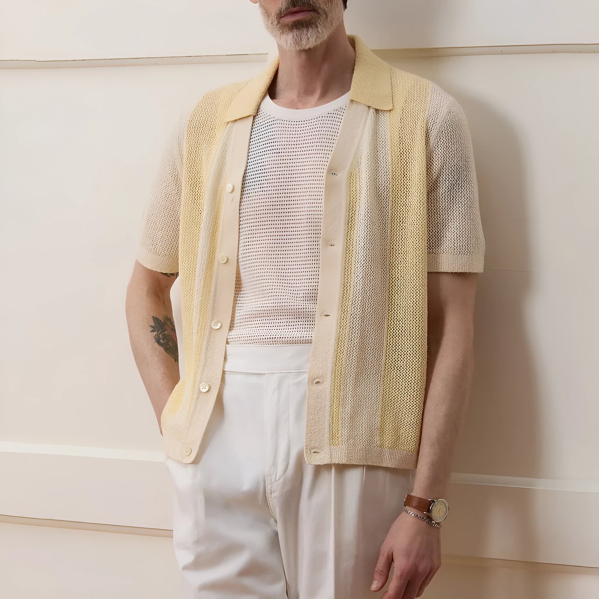 Yellow men's casual polo shirt with hollow-out detailing and an asymmetric short sleeve hem.