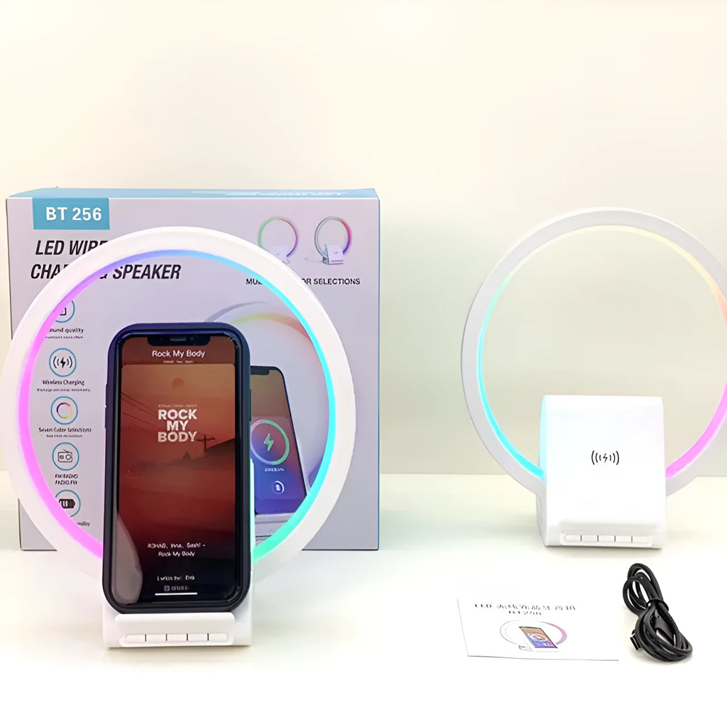 White smart Bluetooth speaker with wireless charging pad and ambient lighting on desktop