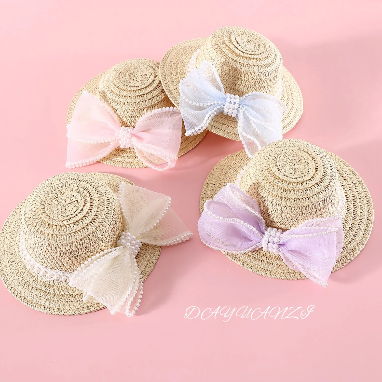 Woven straw hat for a cat with a large central pearl bow, available in blue, pink, purple, and white.