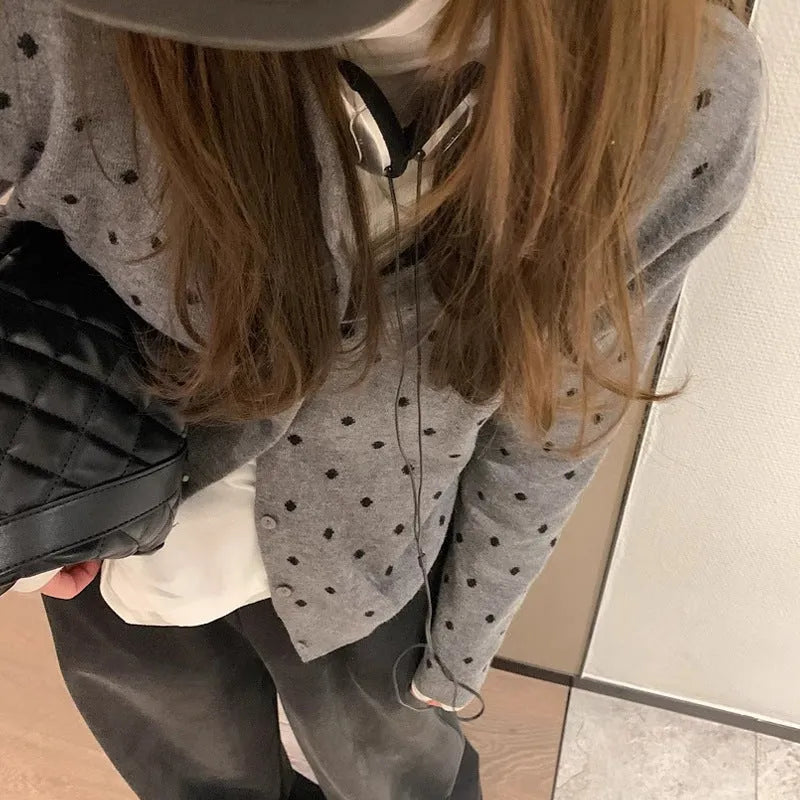 Women's gray dot pattern knitted cardigan with long sleeves and crocheted flower details