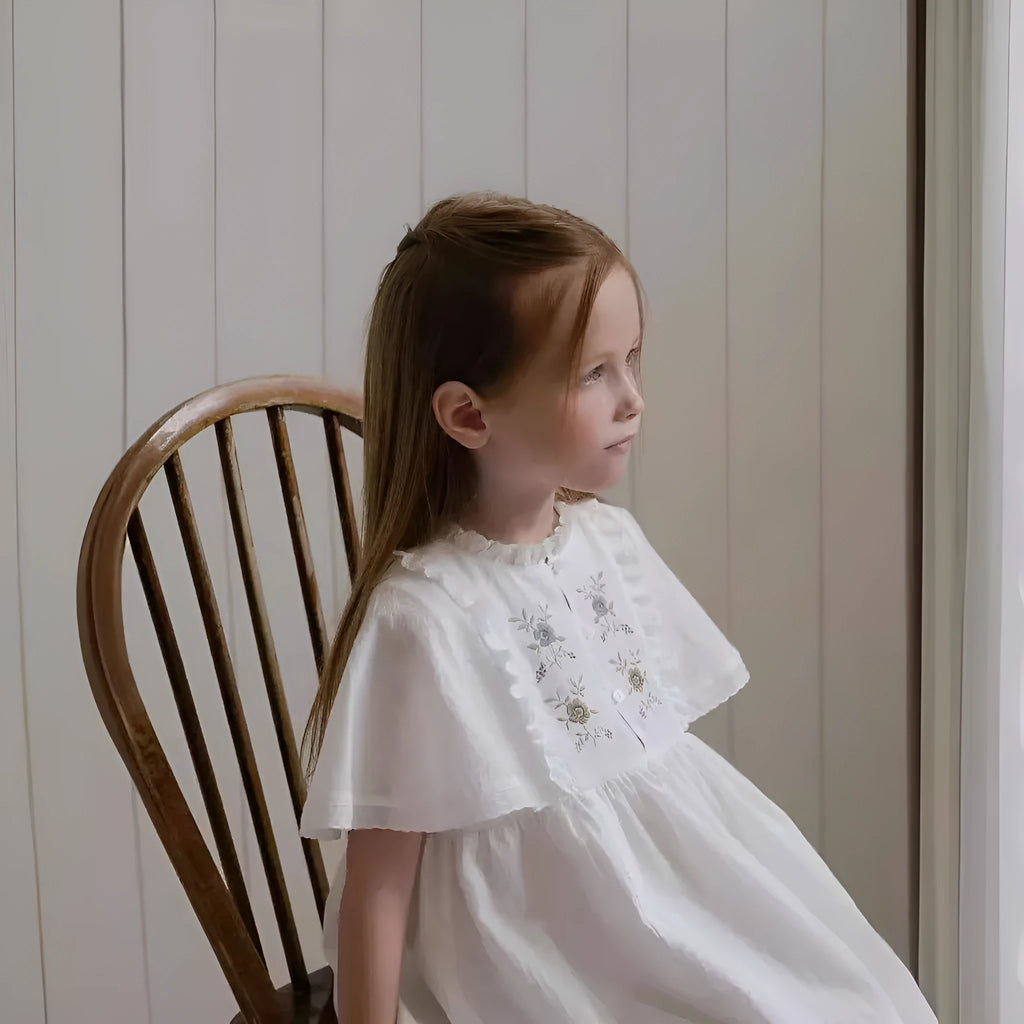 White washed cotton girls dress with short sleeves, ruffled and embroidered skirt for summer
