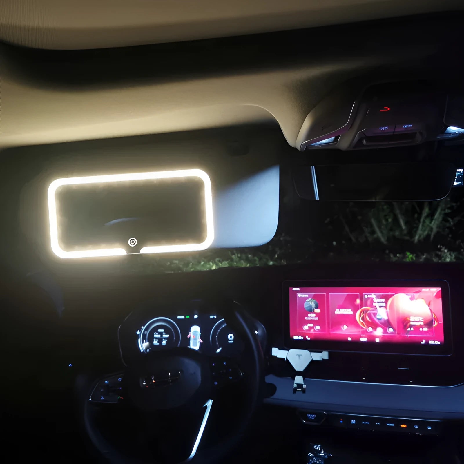 White car sun visor with LED make-up mirror showing illuminated reflection on aluminium surface