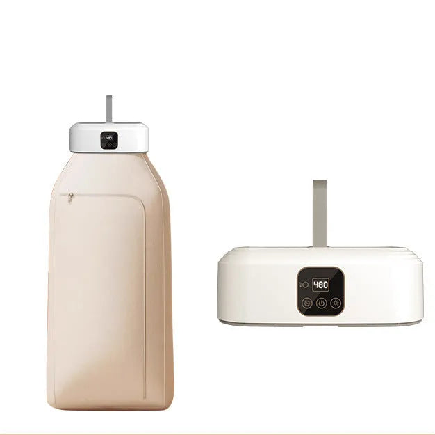 White cylindrical compact foldable laundry dryer with remote control on a table.