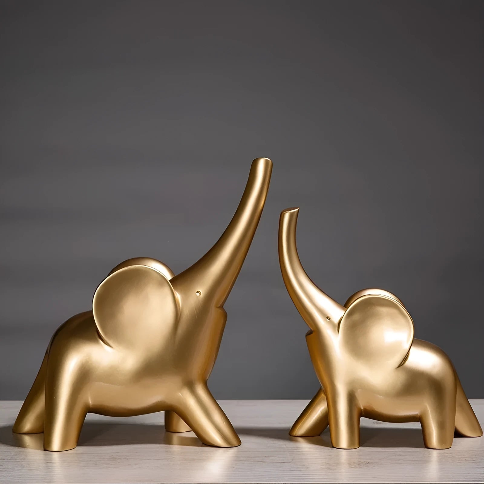 Modern resin elephant ornament in rose gold or white colour, available in large and small sizes.