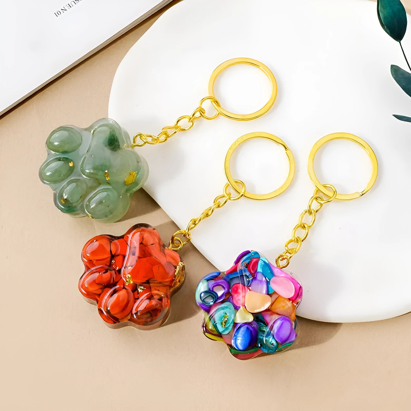 Small natural crystal cat's paw keychain pendant on a metal ring.