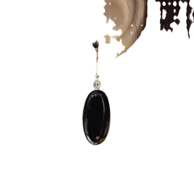 Black agate oval pendant earrings with geometric silver-toned frames and drop earring design