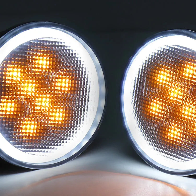 Pair of yellow LED turn signal lights mounted in Jeep Wrangler JK centre grille with ABS polymer housing