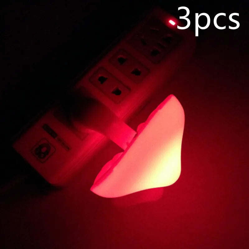Mushroom-shaped LED night light with light sensor, warm yellow glow, plugging into a wall socket