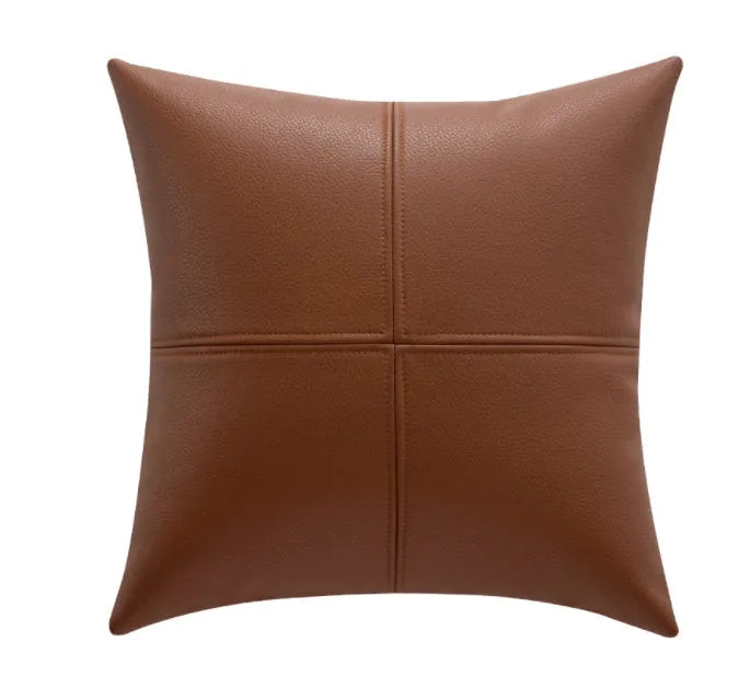 Simple solid colour cowhide leather pillow cover on a sofa, shown in a beige white colour.