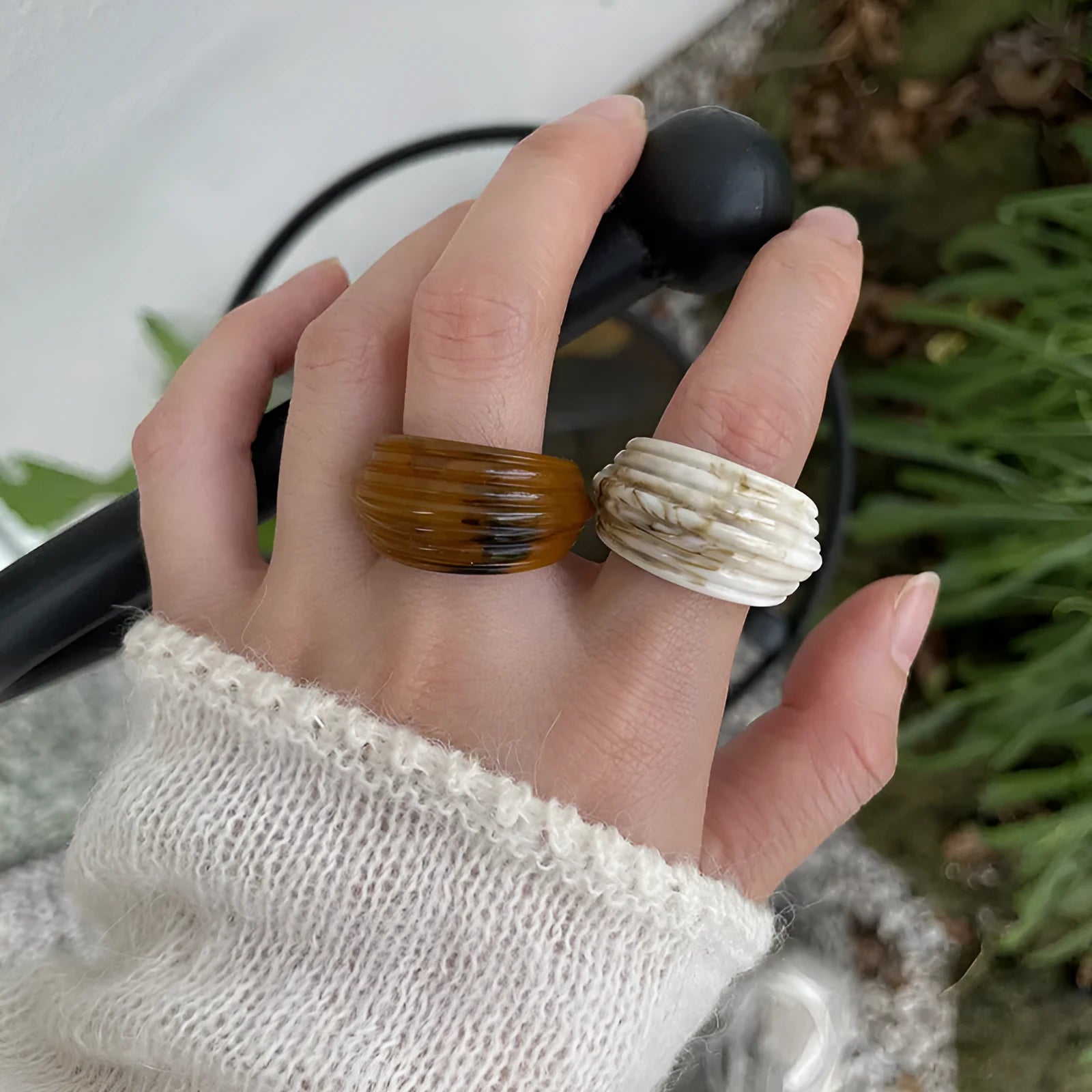 Chinese style irregular geometric resin wide ring in neutral colours on display