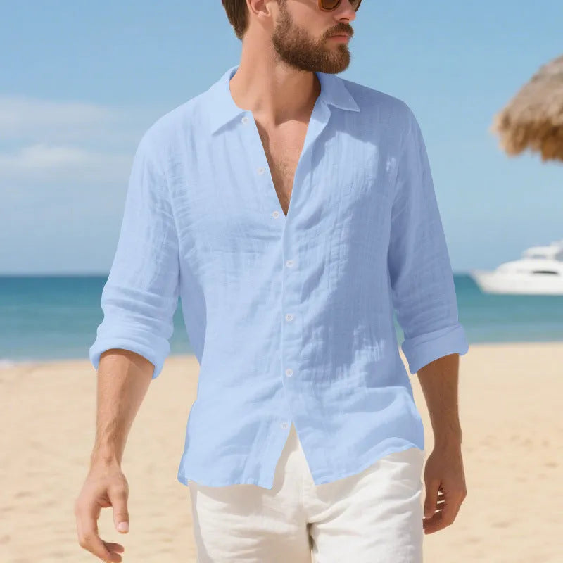 Men's loose fit linen Hawaiian casual shirt on a hanger, shown in light blue colour.