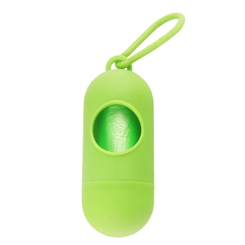 Black plastic dog poop bag holder with a metal side hook and Velcro strap, showing compact size.