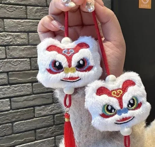Handmade blue and yellow Chinese style plush lion keychain ornament with star stone decoration.