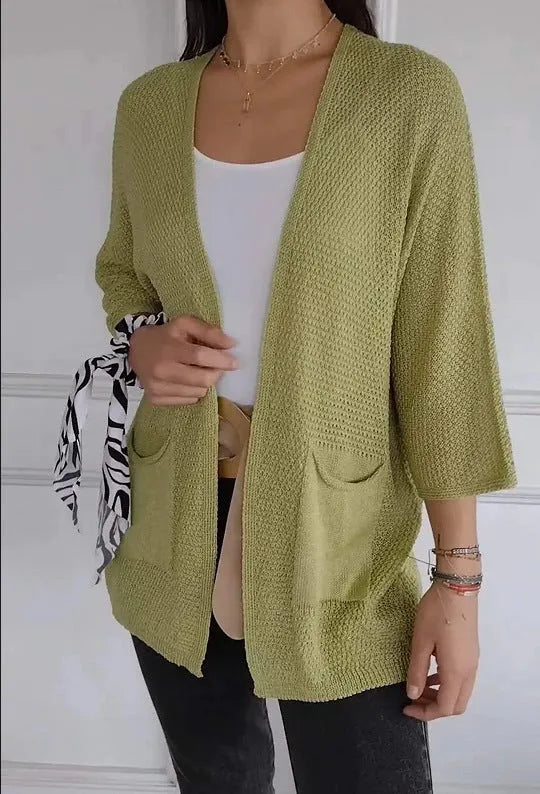 Women's army green waffle knit cardigan coat with nine-quarter sleeves and pockets.