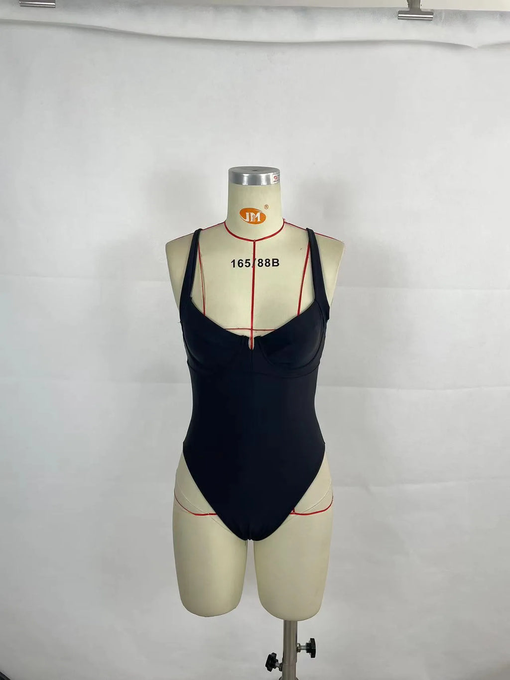 Women's contrast colour one-piece swimsuit in black and red, polyester outer with nylon lining, briefs-style cut for swimming and wading.