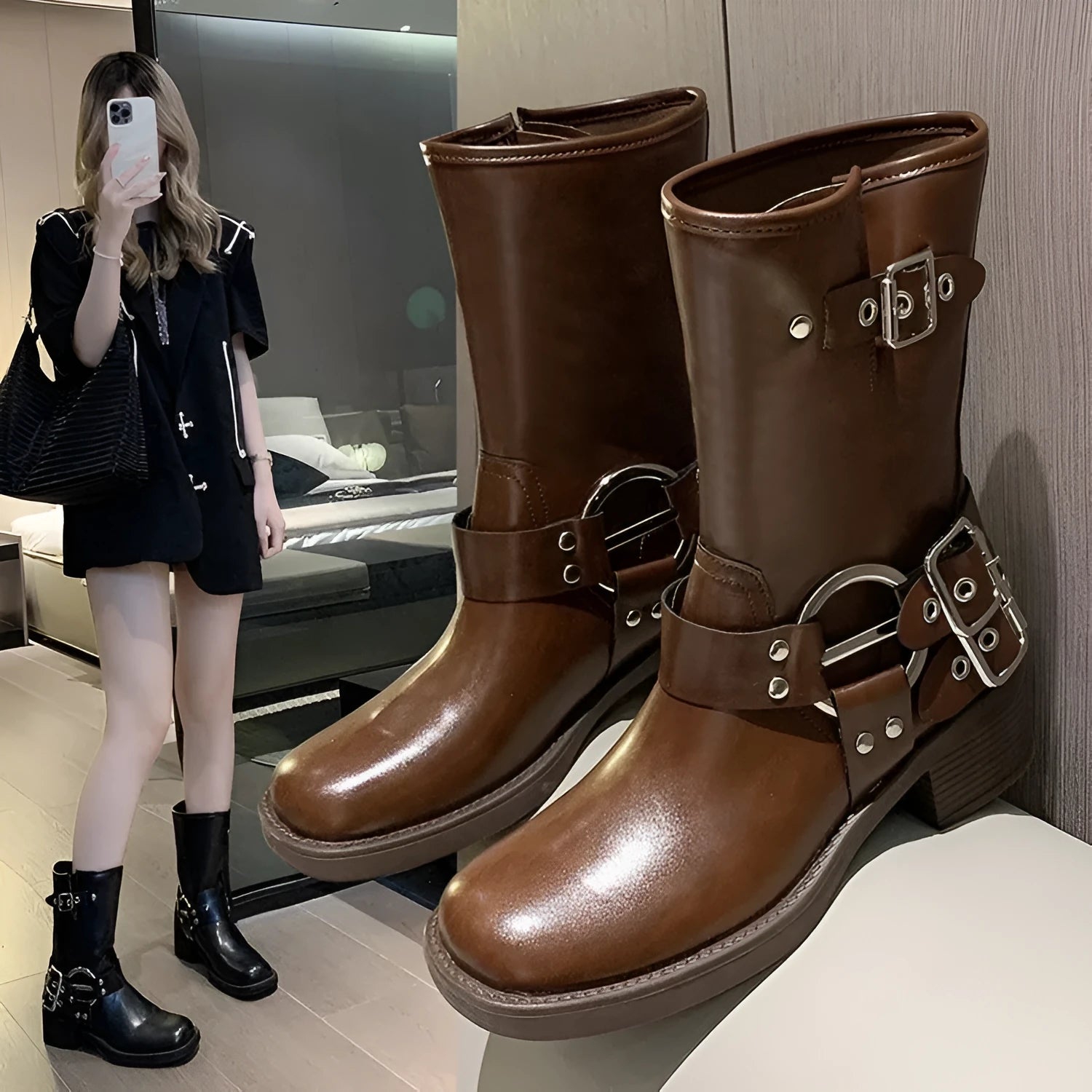 Women's black platform boots with belt buckle detail and lace-up closure, mid-calf length