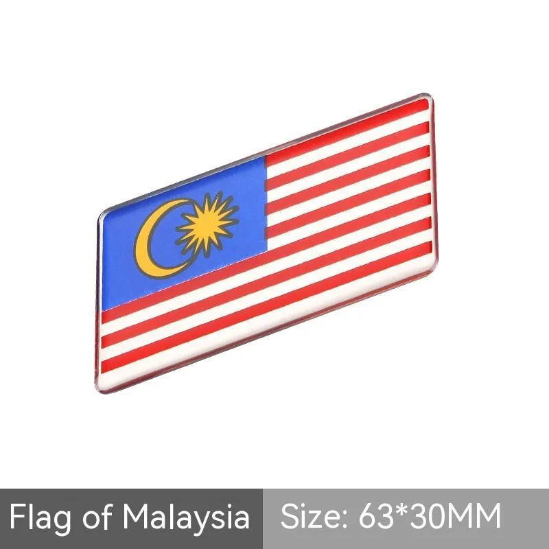 Aluminium parallelogram car sticker showing a national flag design, measuring 6.3 by 3 centimetres.
