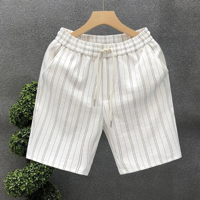 Men's black and white striped fleece-lined casual shorts with an elastic waistband on a grey background.