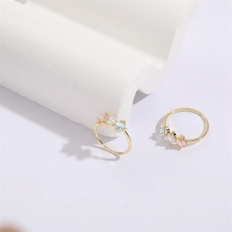 Geometric triangle design women's ring with horse eye motifs and tricolor zircon stones in 14k gold colour