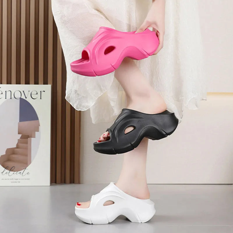 Women's white EVA slippers with a thick sole on a sandy beach background