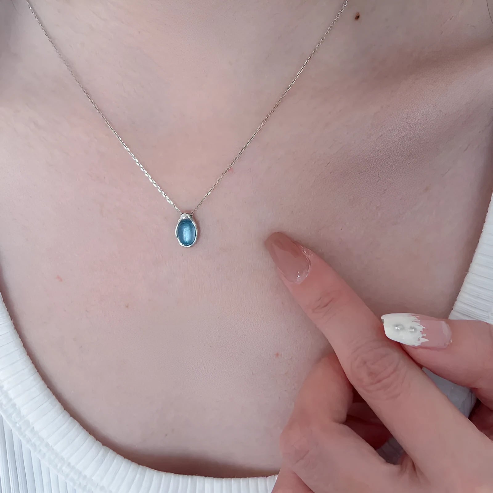 Navy blue water drop pendant necklace with platinum-colour finish on adjustable copper cross chain.